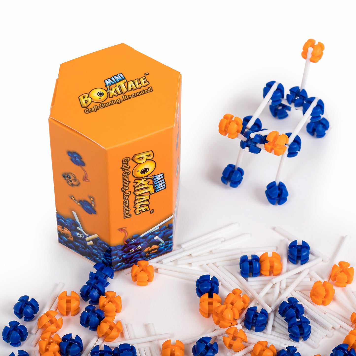 Orange Mini Boxitale box with a constructed vehicle model and scattered blue, orange, and white building pieces