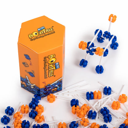 Orange Mini Boxitale box with a constructed vehicle model and scattered blue, orange, and white building pieces