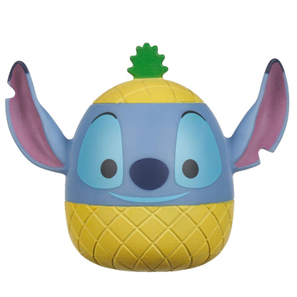 A blue egg-shaped Squooshems Stitch toy with large ears, a yellow pineapple-textured body, and a green leaf top