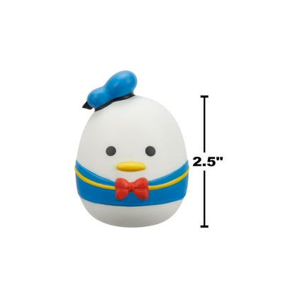 Front view of a 2.5-inch Squooshems toy shaped like a round duck character wearing a blue sailor outfit, red bow tie, and blue hat
