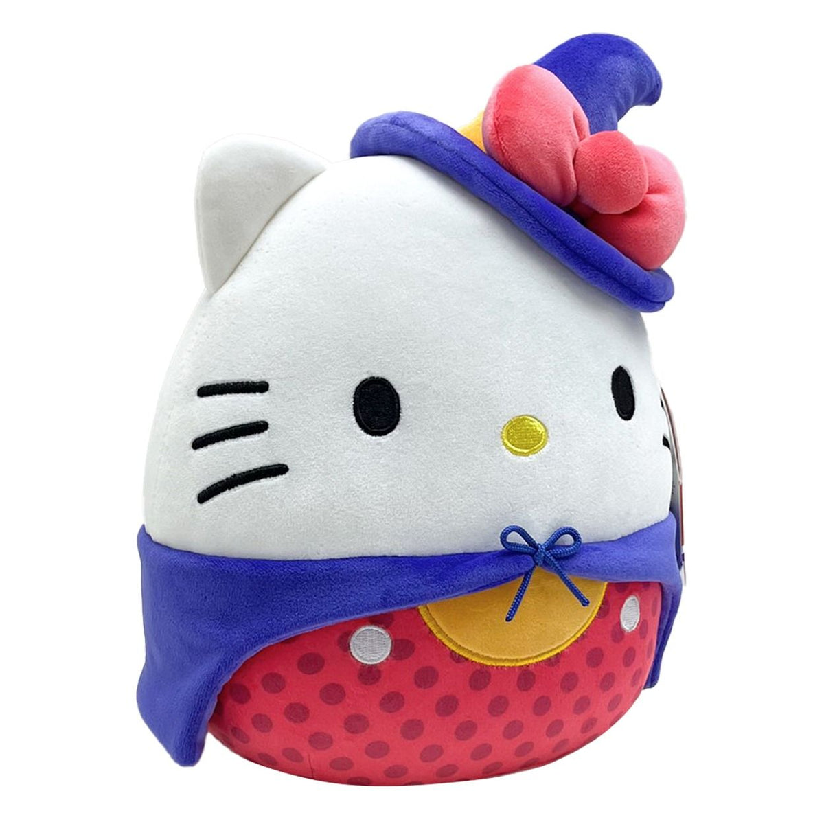Close-up of an 8-inch Hello Kitty Squishmallow featuring a white head, blue wizard hat with a pink bow, blue cape, and a plump red polka dot base