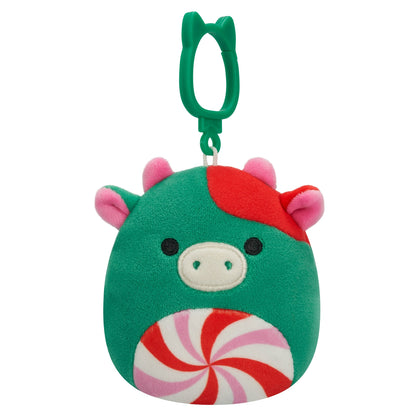 Green plush cow clip with red accents and a swirl candy belly hanging on a green carabiner