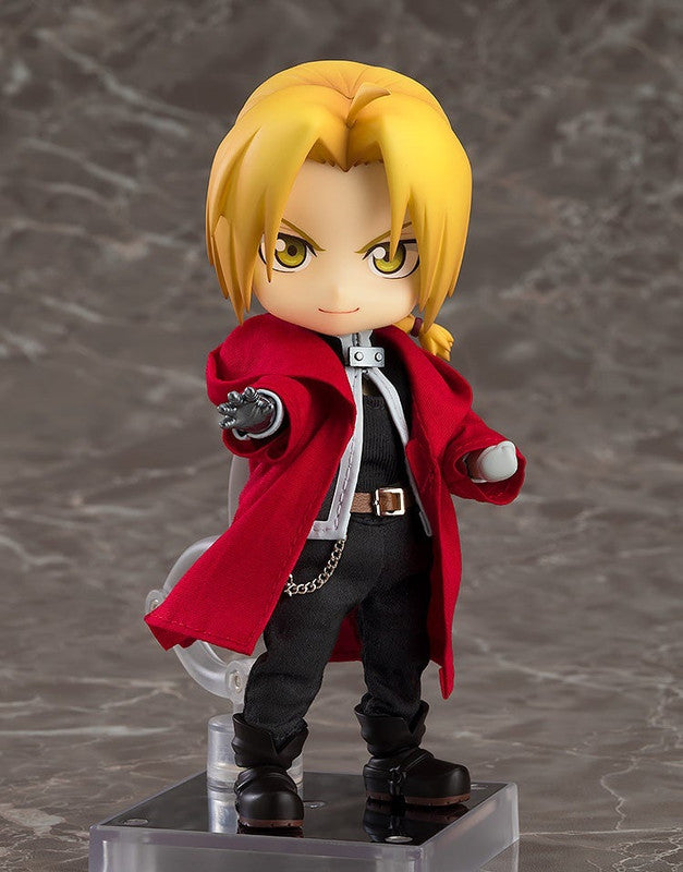 Nendoroid figure of Fullmetal Alchemist Edward Elric in red coat, extending his automail arm on color background