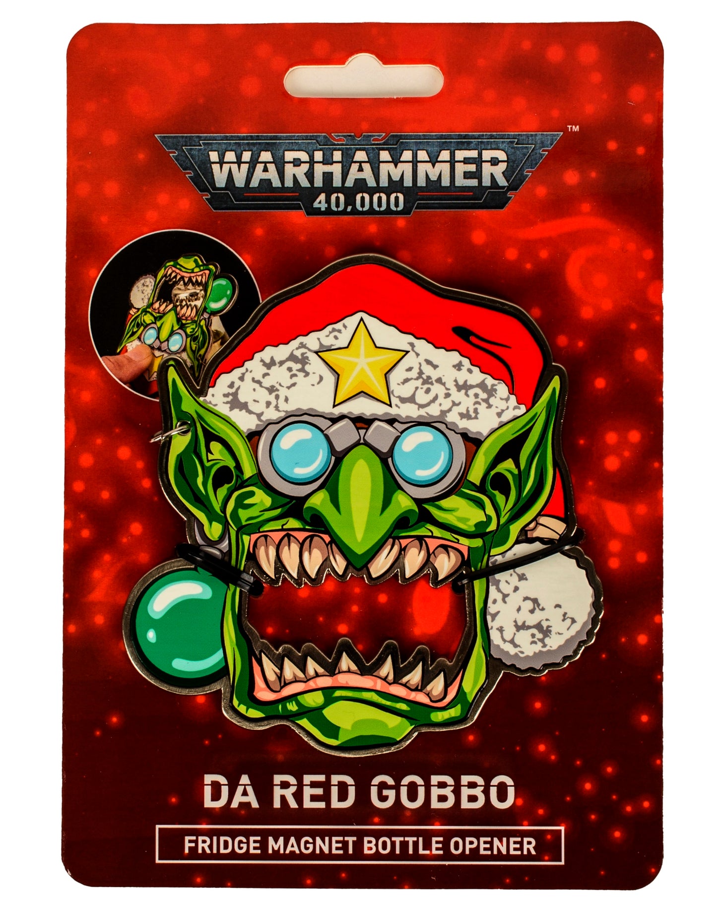 Warhammer 40,000 Da Red Gobbo fridge magnet bottle opener. Green goblin character wearing a Santa hat with a star, packaged on a red card
