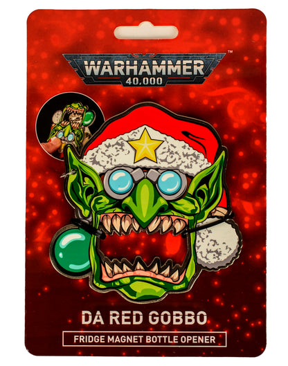 Warhammer 40,000 Da Red Gobbo fridge magnet bottle opener. Green goblin character wearing a Santa hat with a star, packaged on a red card