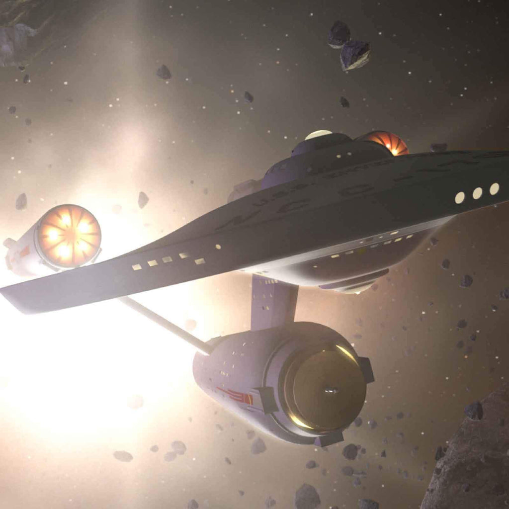 The Starship Enterprise with bright, glowing engines maneuvers through a field of space debris