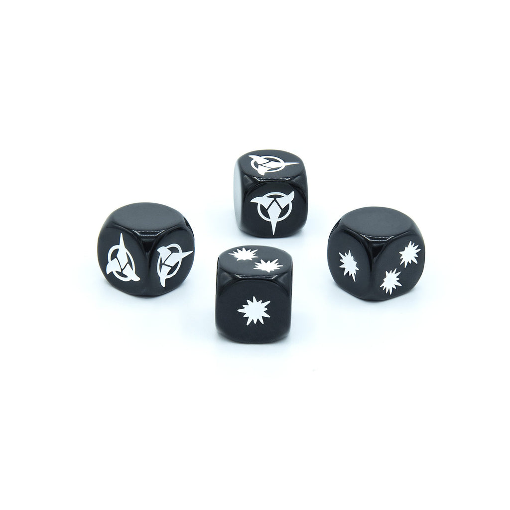 Four black Star Trek dice with white Starfleet symbols and starbursts on a white background