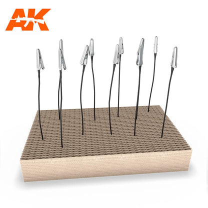 AK model painting stand: a textured base holds flexible black rods -  each with a silver clip for holding parts