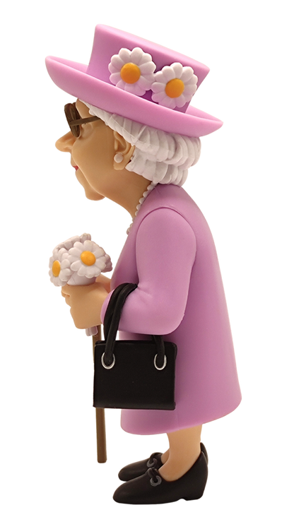 Side view of Minix Queen Elizabeth II vinyl figure in a pink coat and hat with white daisy details holding a black handbag and flowers with a walking stick