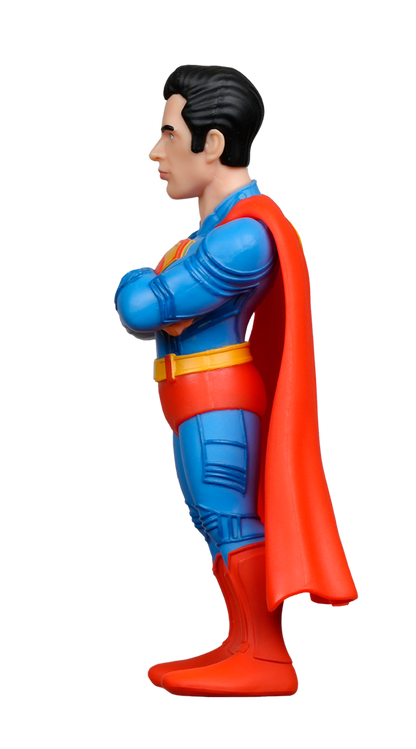 Side view of the MINIX DC Comics Superman 2025 Figure with arms crossed, wearing his iconic blue, red, and yellow suit with cape