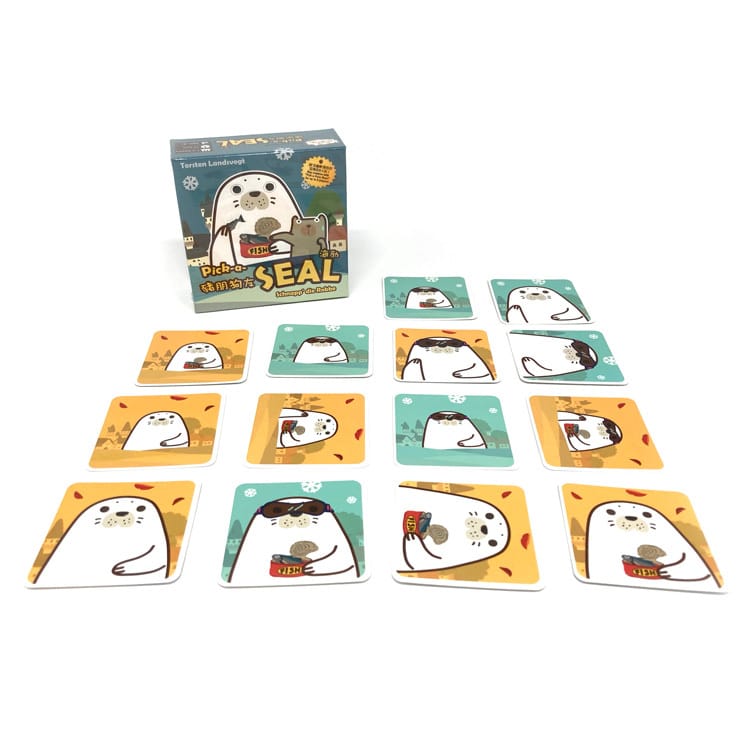 Top-down view of the Jolly Thinkers card game components including cards, tokens, and instruction booklet arranged neatly on a white background