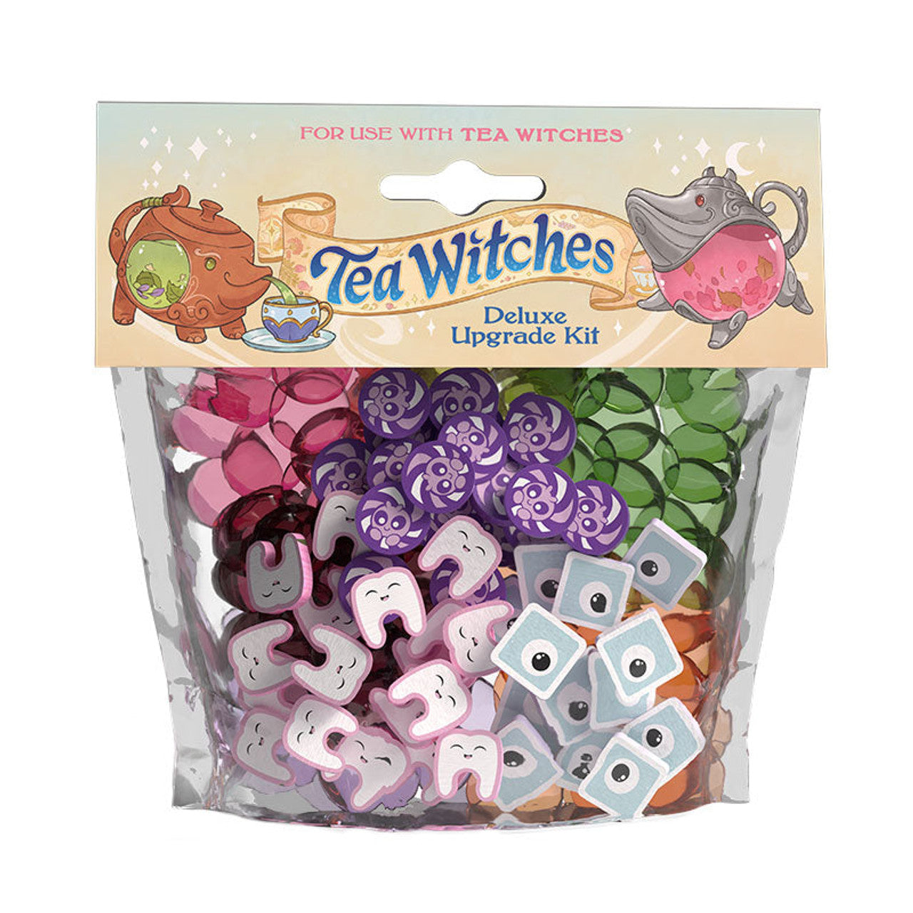 Tea Witches Deluxe Upgrade Kit with tokens shaped like teeth, eyes, and swirls, plus colored translucent gems