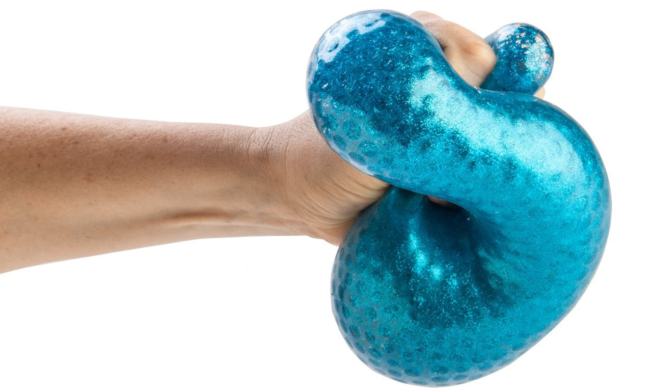 Hand squeezing a large, textured blue glitter stress toy