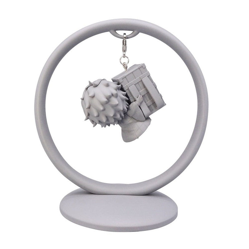 Gray monochrome anime keychain of a character carrying a box