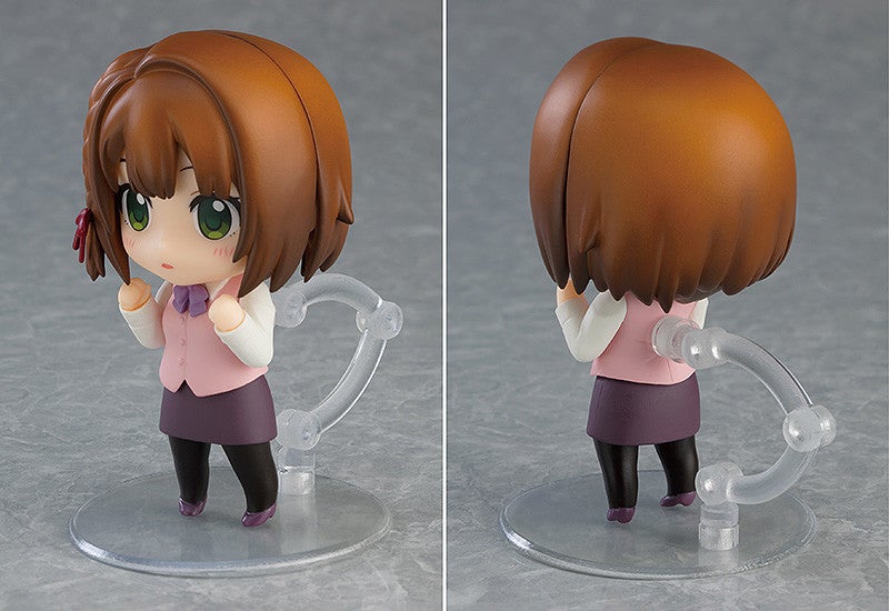 Adorable Nendoroid anime figure of a girl with short brown hair green eyes and a purple bow tie wearing a pink vest