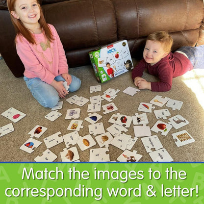 Two children playing an educational ABC puzzle matching game on the carpet