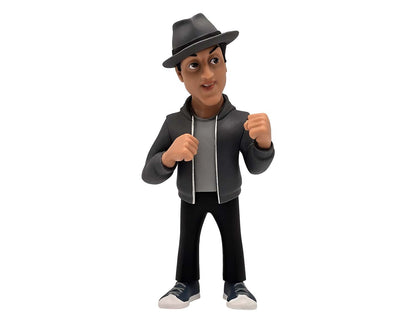 Side angle showing facial detail, raised eyebrow, and jacket wrinkles