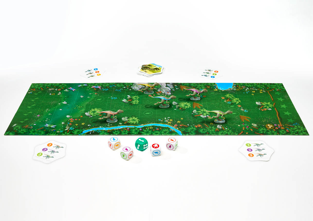 Raptor Race board game features a green jungle map with dinosaur miniatures, several dice, and various game cards
