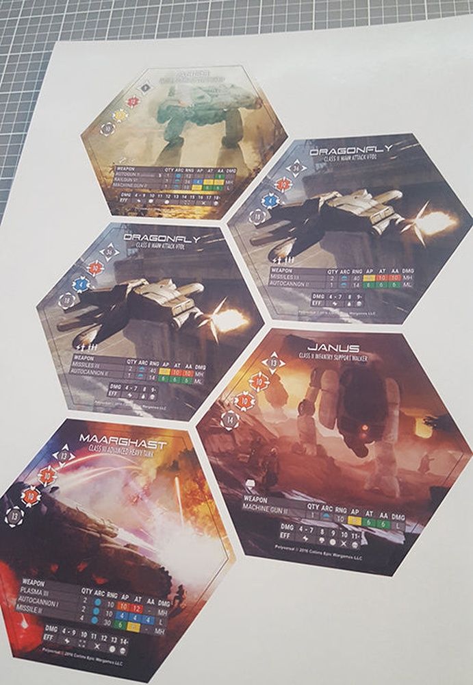 Collectible strategy game unit tokens featuring Dragonfly VTOL Janus support walker and Maarghast heavy tank with detailed stats on a light background