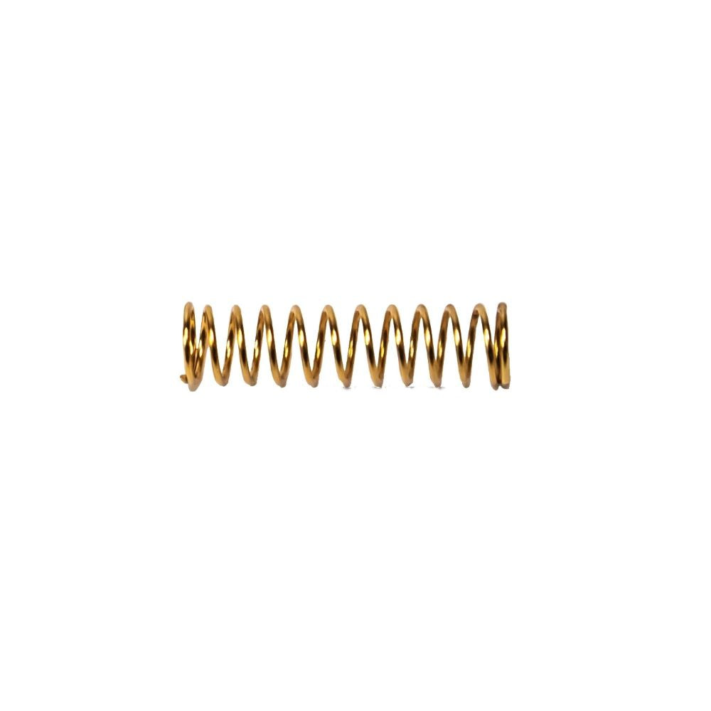 A horizontal golden compression needle spring on a white background