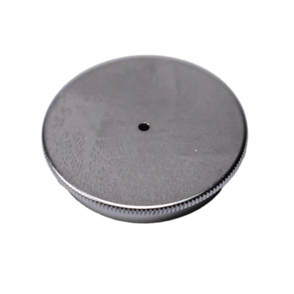 A round, silver metallic cap with a knurled edge and a small hole in the center