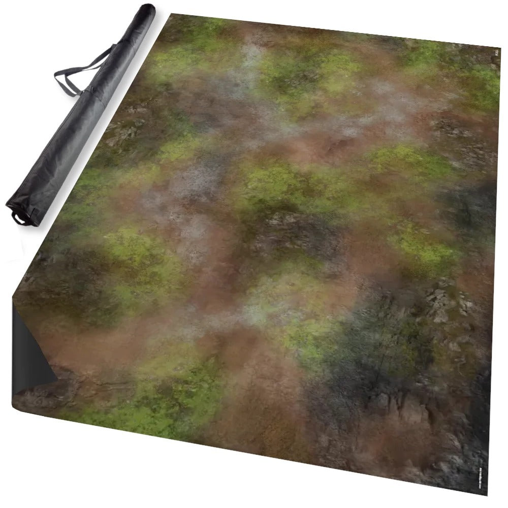 Unrolled tabletop terrain mat with natural green and brown landscape pattern, next to a black carrying case
