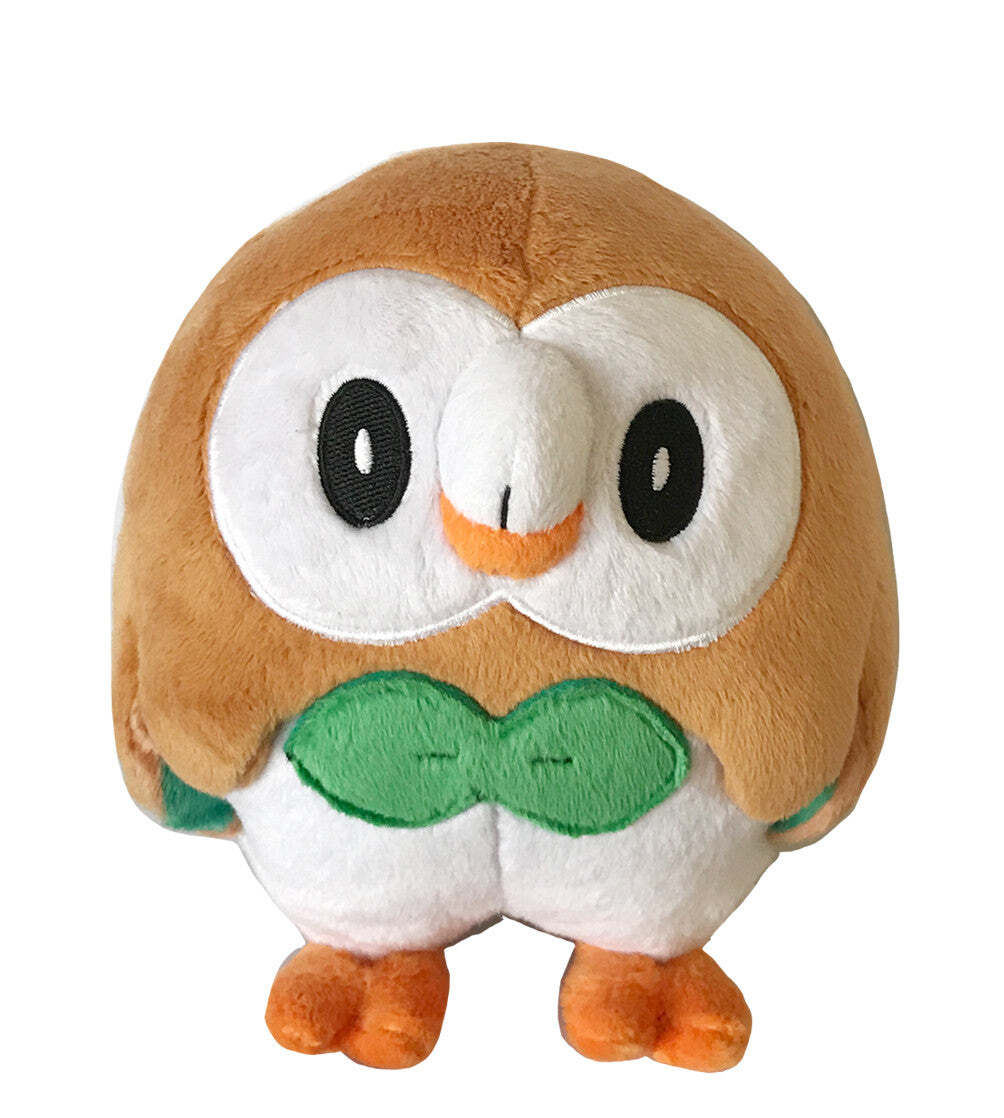 Rowlet PokÃ©mon plush toy featuring a brown and white body, green bow tie, and orange beak and feet, isolated on white