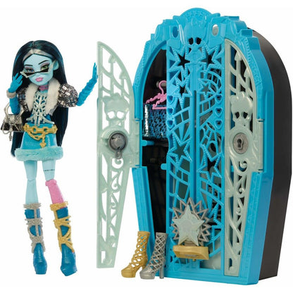 Monster High Frankie Stein doll with dark hair, sunglasses, fur coat, and mismatched boots stands by an open blue coffin-shaped locker displaying doll shoes