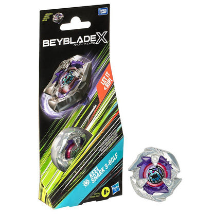 A silver and purple Beyblade X 'Keel Shark 3-60LF' toy shown out of its black and colorful packaging