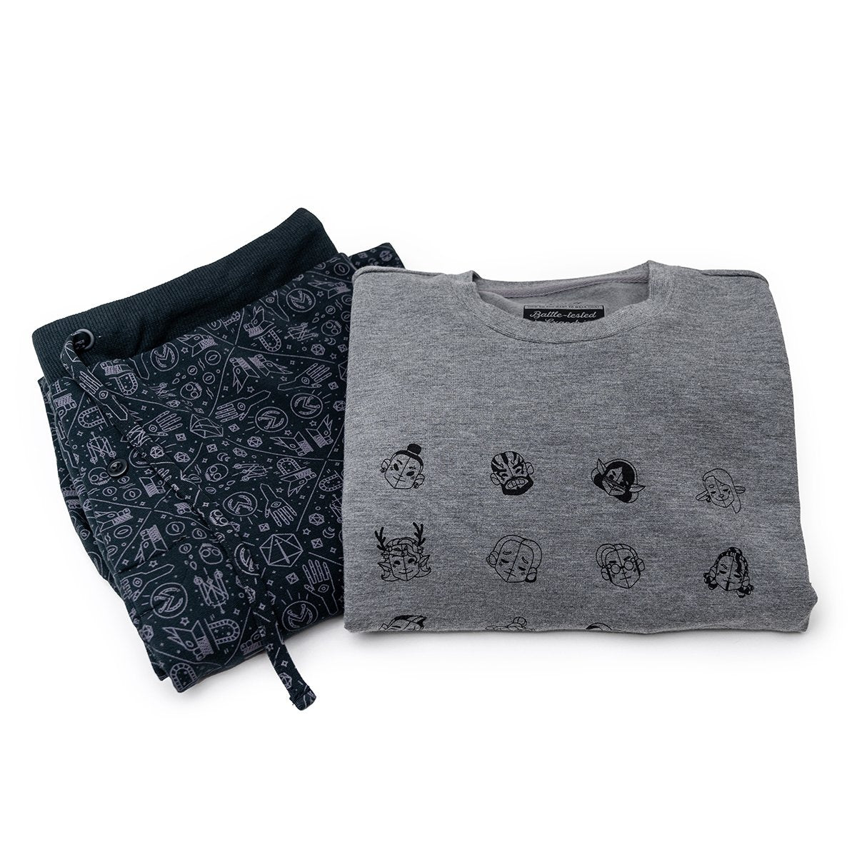 Folded grey Ultra Soft lounge set with character faces and dark patterned sweatpants featuring gaming symbols, on a white background