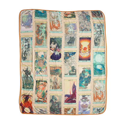 A rectangular Oracle of the Moon Blanket patterned with a grid of fantasy illustrations resembling tarot cards, with an orange border