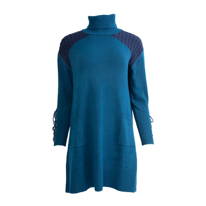 Teal turtleneck sweater dress with dark blue cable-knit shoulders, lace-up cuffs, and front pockets