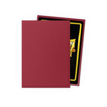Matte burgundy card sleeve covering a trading card with a gold border and black background
