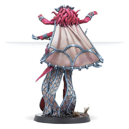 Painted miniature of a red daemon-like figure spreading arms, draped in a large cape, and standing on lattice-work legs