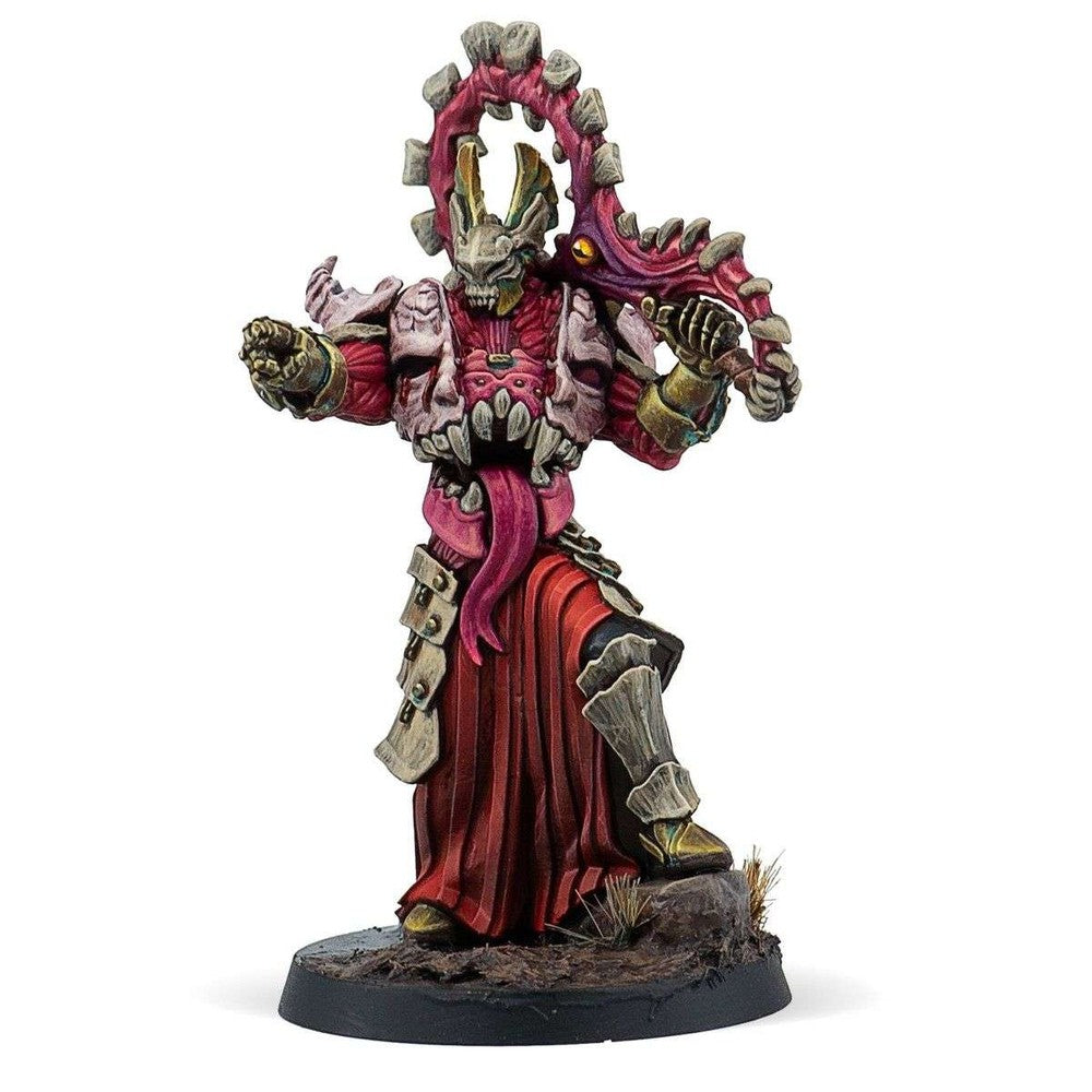 Painted miniature of a grotesque warrior in red robes, featuring a skull mask, protruding tongue, and bone crest