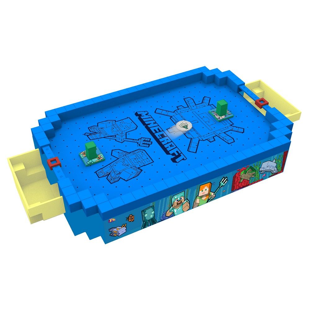 A blocky blue Minecraft tabletop game, resembling air hockey, with green obstacles and yellow goals