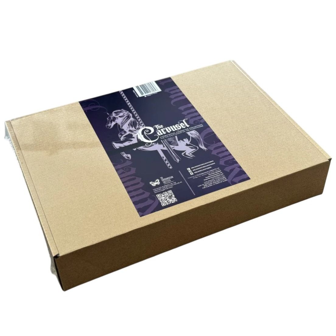 A brown cardboard box with a dark purple label featuring white carousel horses and the title The Carousel