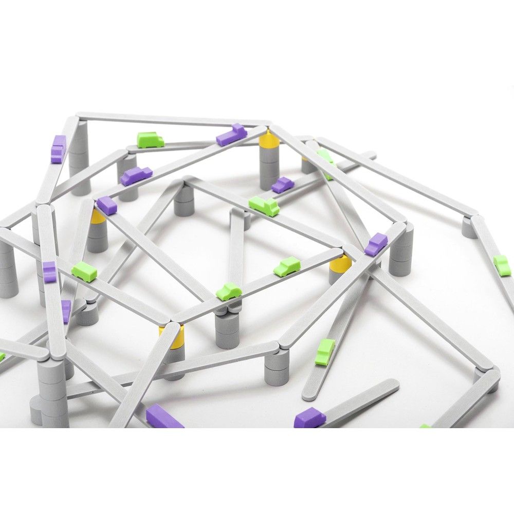 Complex toy structure of interlocking gray roads, supported by pillars, with small green and purple cars