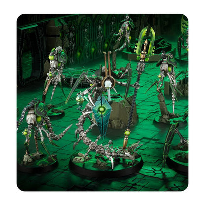 Necron Warhammer 40K miniatures: metallic robots with bright green glow, including a large central destroyer unit, posed on a glowing sci-fi battleground
