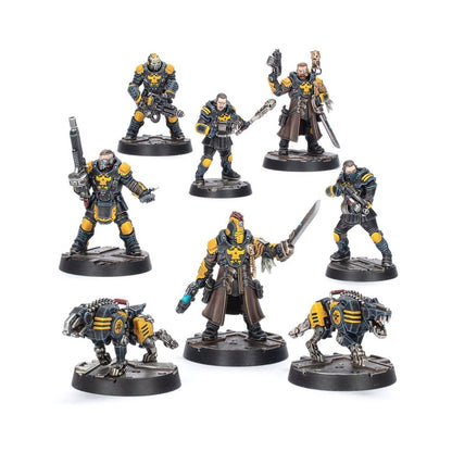 Seven painted sci-fi miniatures: five armored figures with weapons and two black/yellow robotic dogs standing on bases
