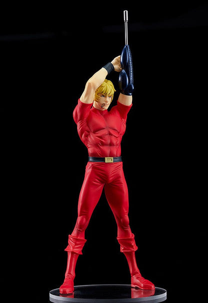 Vibrant red action figure with defined musculature holding a futuristic rifle above his head on a black background