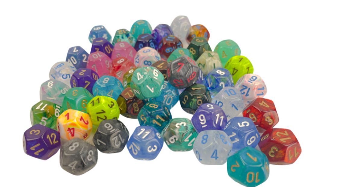 A vibrant pile of colorful polyhedral dice scattered on a white background