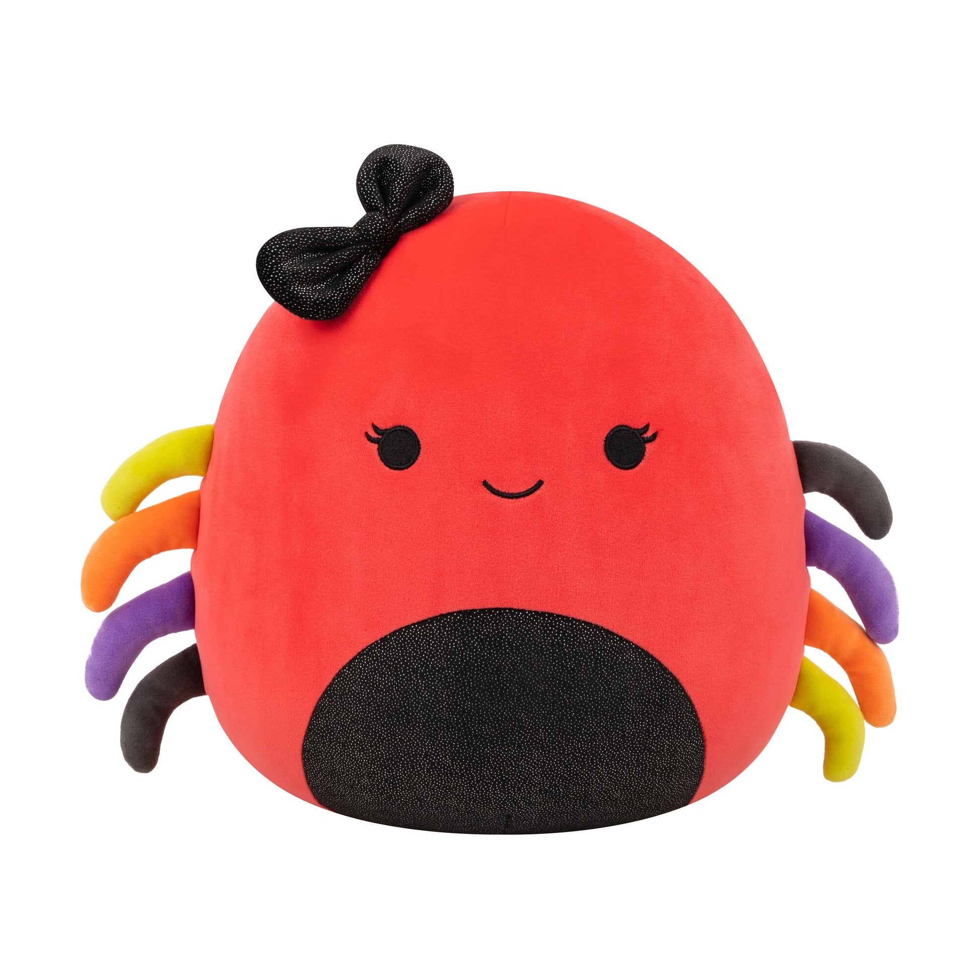 A red plush spider toy with a black glitter bow, a smiling face, and multicolored yellow, orange, purple, and dark gray legs