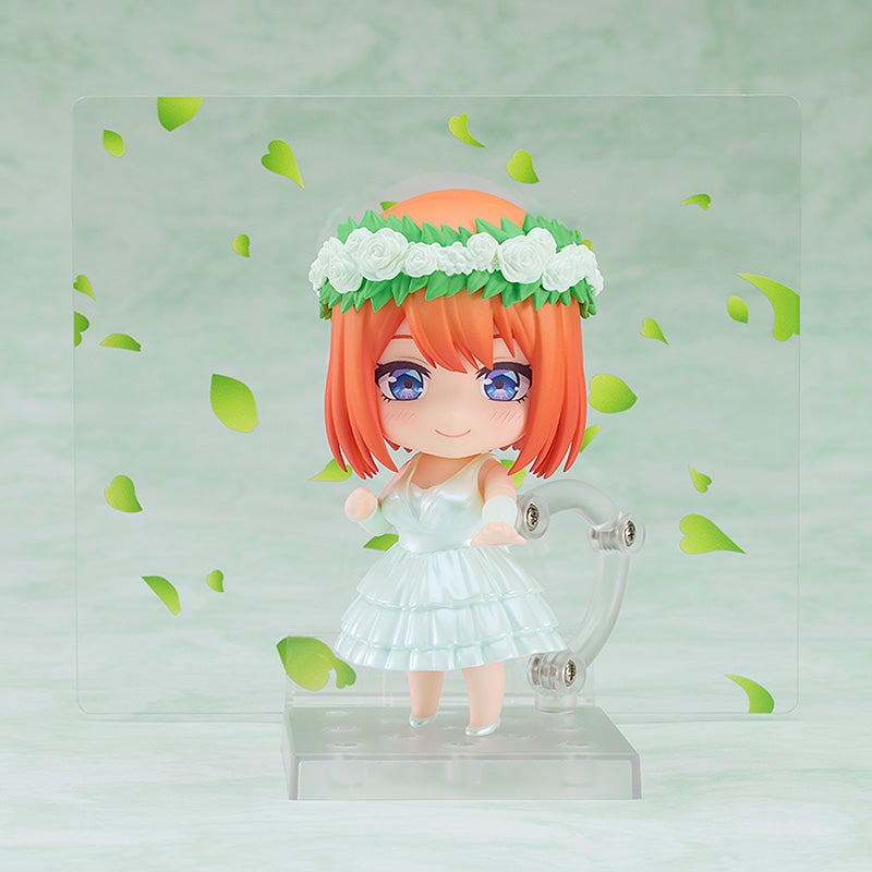 Figure of a girl with orange hair blue eyes wearing a white flower crown and a ruffled dress standing on a clear base