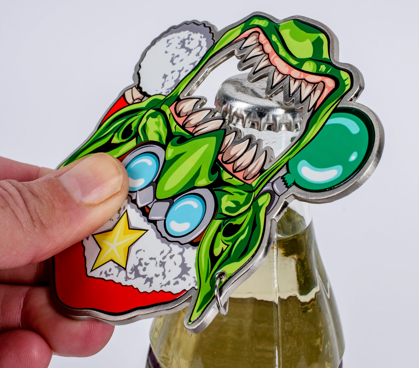 Green monster bottle opener shaped like a cartoon Krampus or zombie Santa, being used to open a capped glass bottle