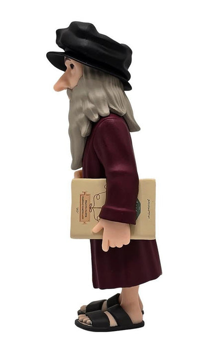 Side view of Minix Historical Leonardo da Vinci 67 collectible figure with grey beard black hat long maroon robe and tan tunic holding a book wearing sandals