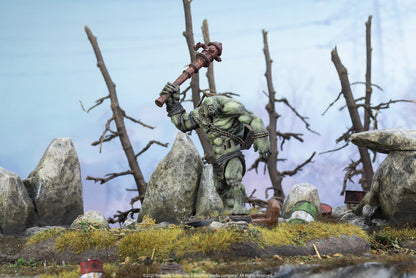 A green Fallout Super Mutant miniature raises a fire hydrant club overhead in a desolate, rocky landscape.