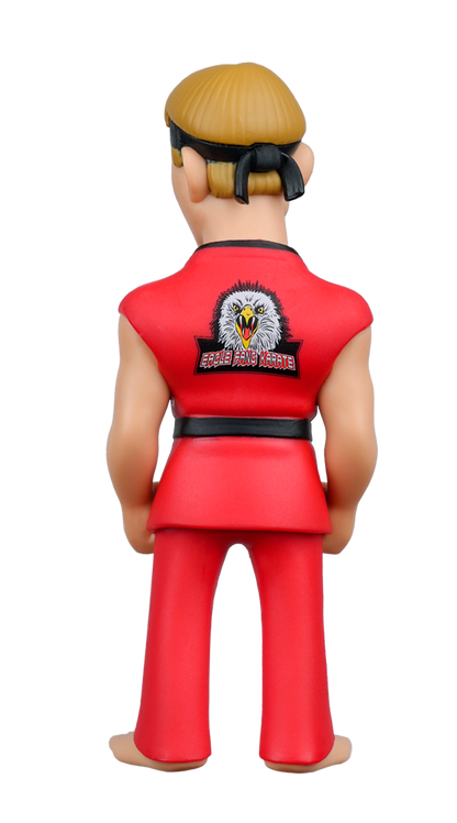 Back view of a blonde figure in a red karate gi with a black belt and an Eagle Fang Karate eagle design