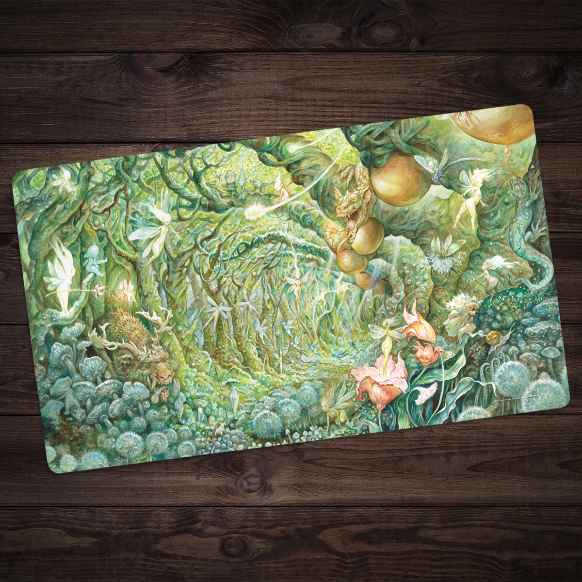 A lush green fantasy Gaea In Bloom playmat showing watercolour artwork of a fairy forest, ancient trees, and pink flowers against dark wood