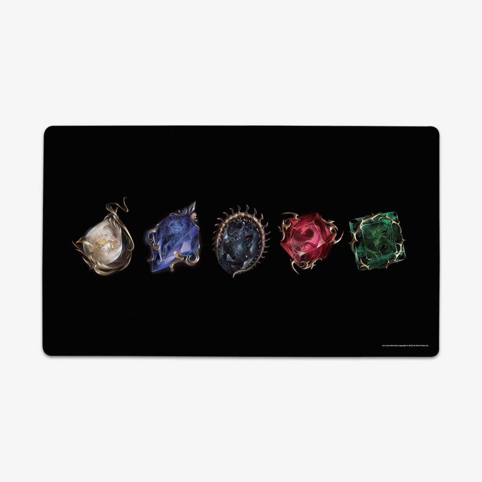 Black mat displays five ornate, gold-framed gem-like objects with fantasy creature designs: white, blue, dark, red, green